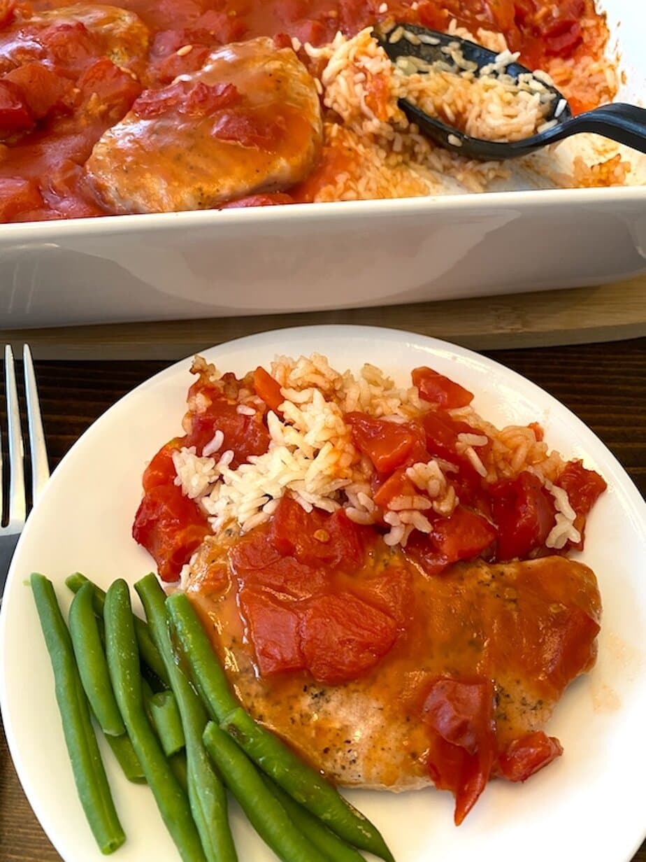 pork chop with tomato gravy and rice with a side of green beans