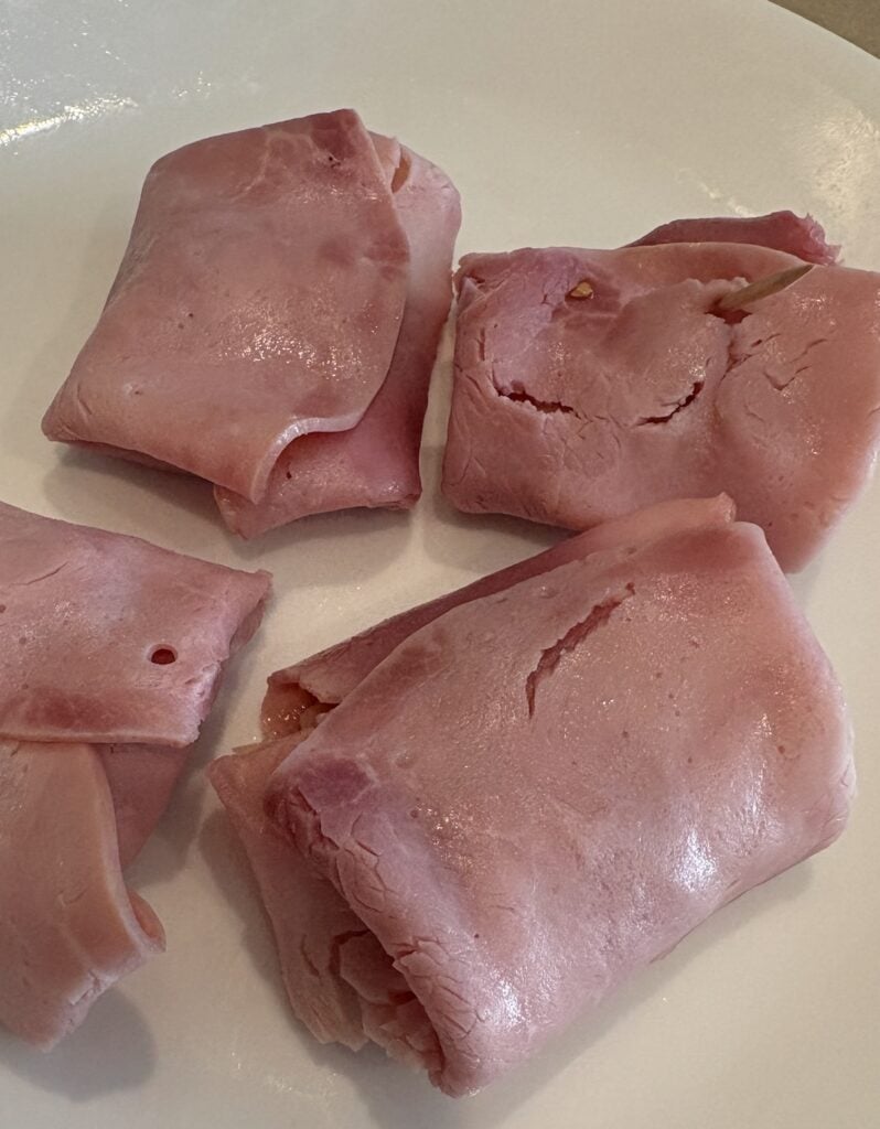 folded ham and cheese pockets on a plate