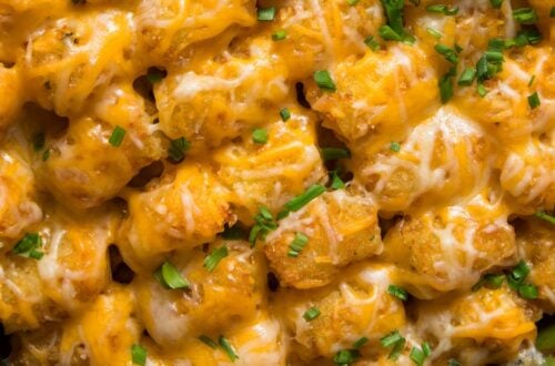 pan of hamburger tater tot casserole with cheese and chopped chives