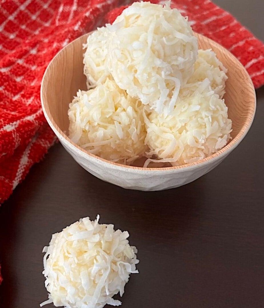 coconut balls in a bowl and on the table
