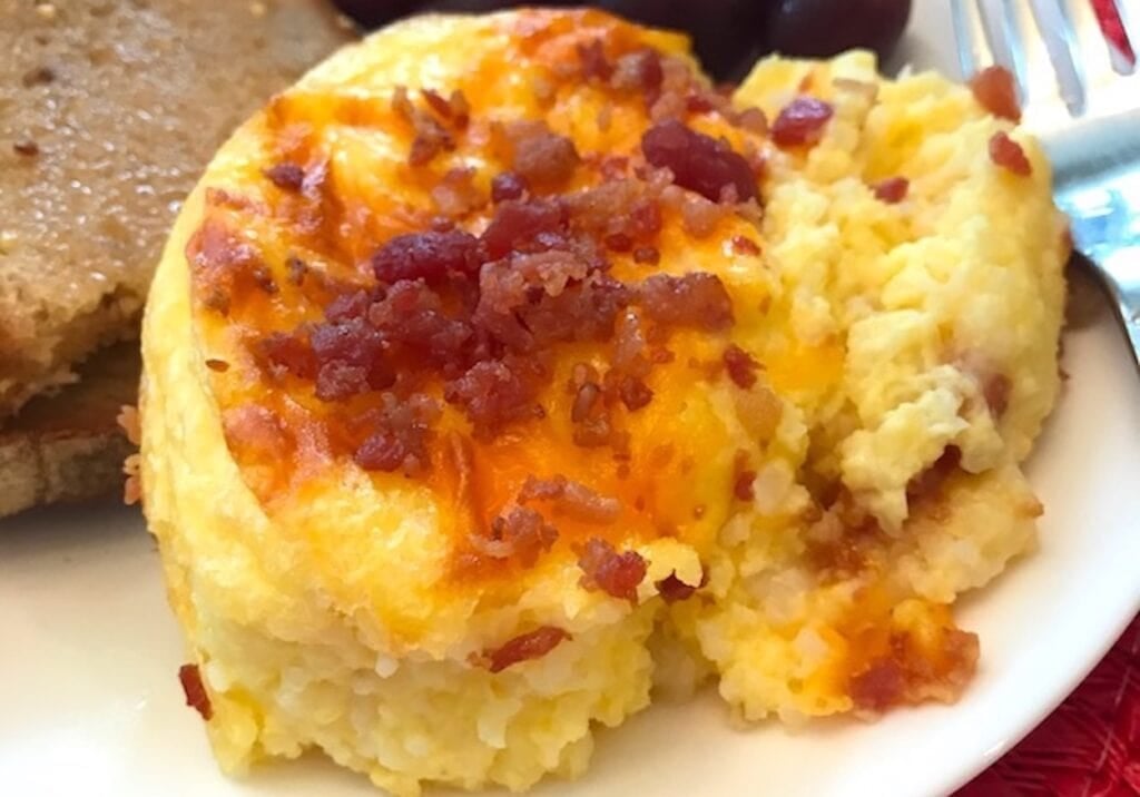 cheesy baked grits casserole topped with bacon bits