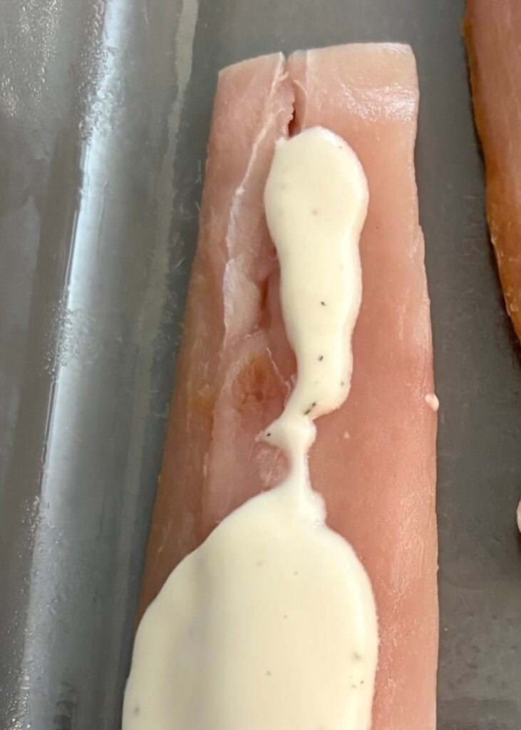 spoonful of ranch dressing on raw fish