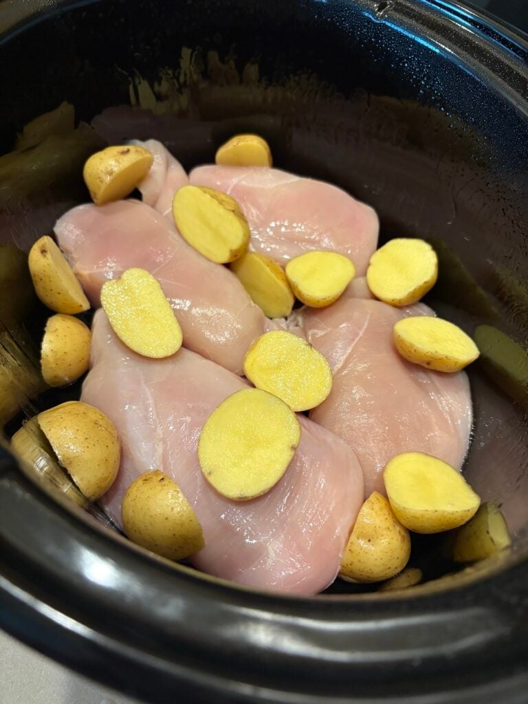 raw chicken and potatoes in crock pot