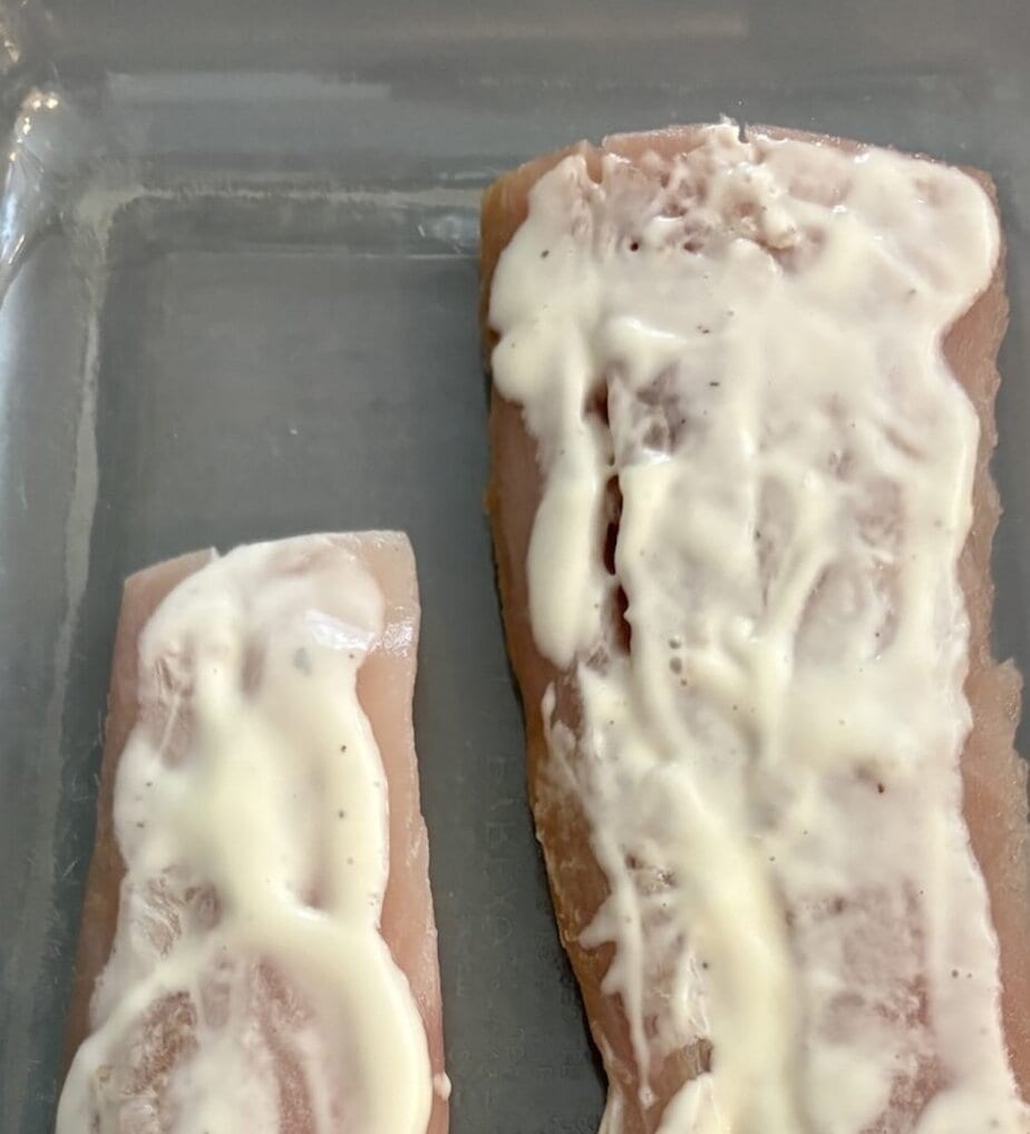 ranch dressing spread over raw fish