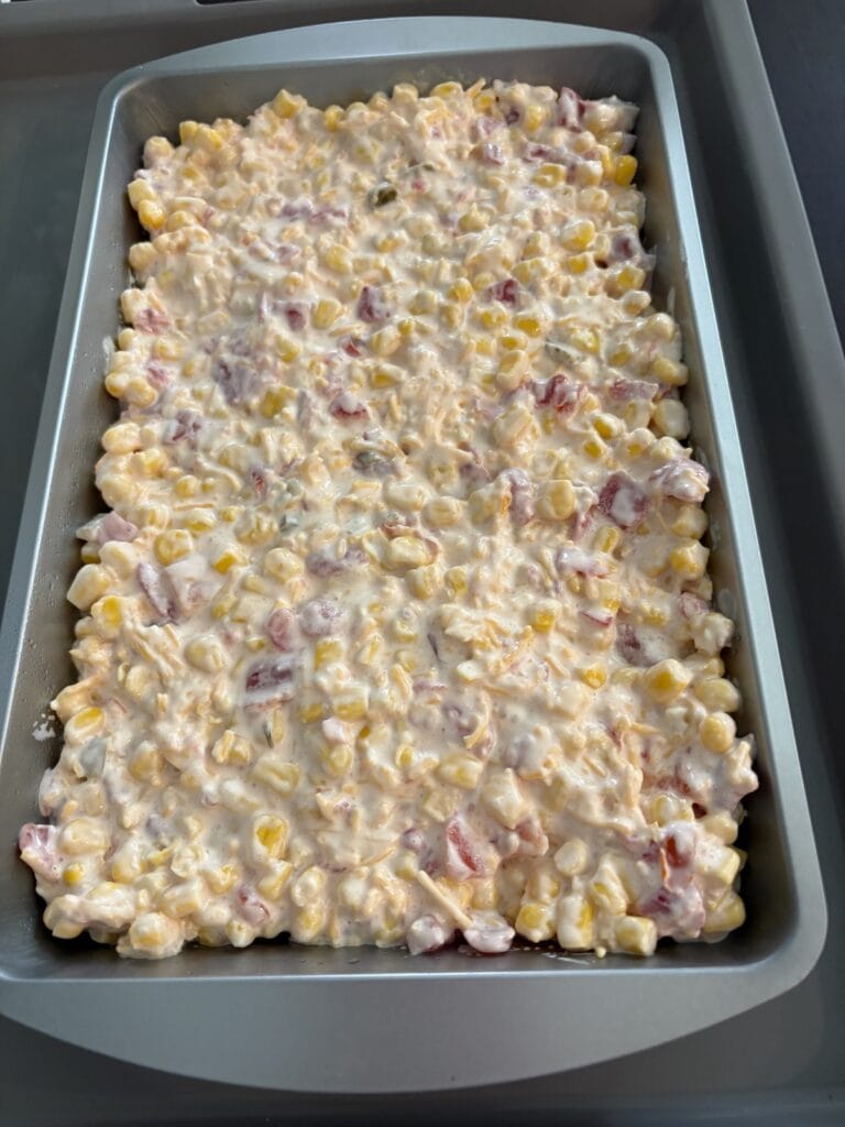 uncooked cream cheese rotel corn dip in a pan