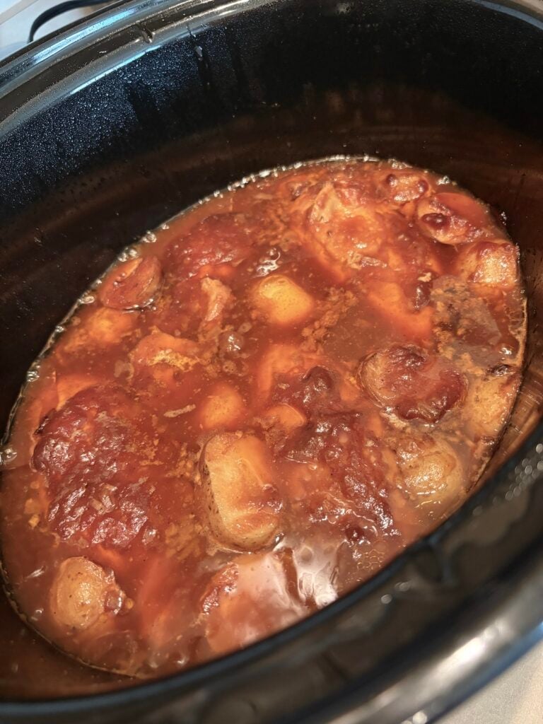 cooked bbq chicken and potatoes in crock pot