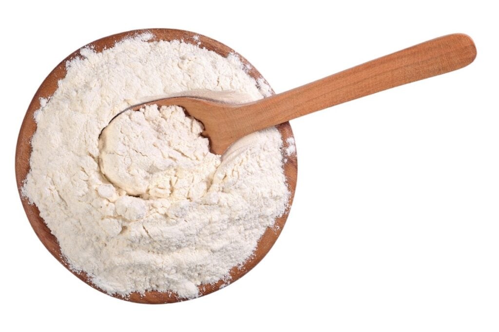 bowl of flour with wooden spoon