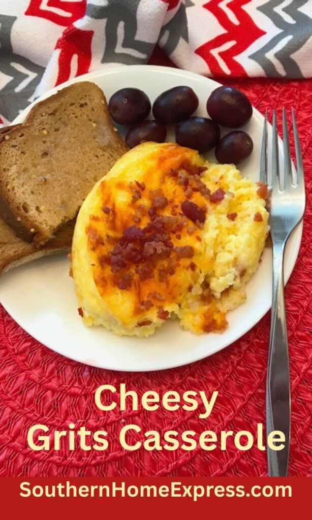cheesy grits casserole on a plate with toast and grapes